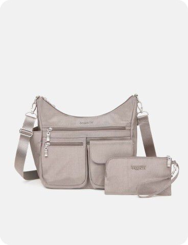 A light gray crossbody bag with multiple zippered pockets is displayed alongside a matching wristlet pouch.